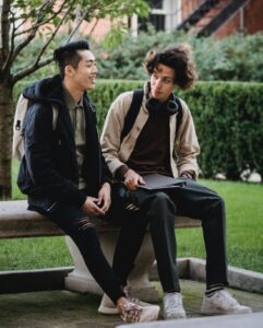 two teenagers sitting together reading body language
