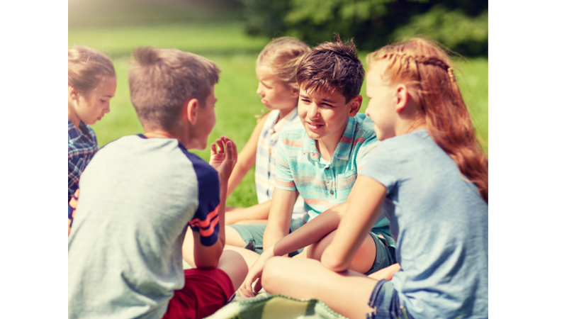 group of friends talking on the grass